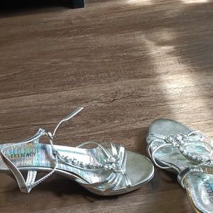 A silver glass shoe with beads and a butterfly